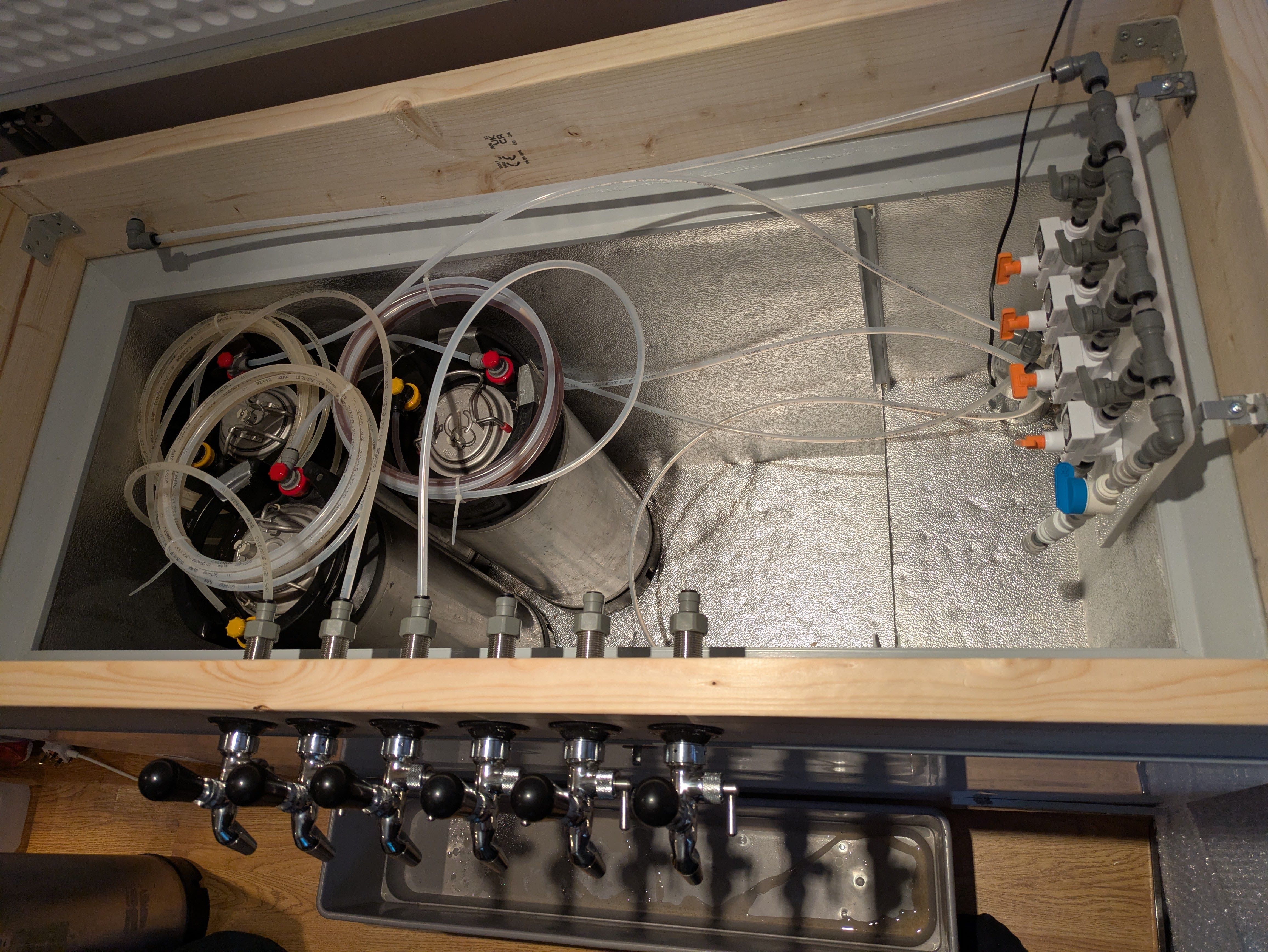 The first three kegs in the keezer, with beer lines attached between keg and tap shank.