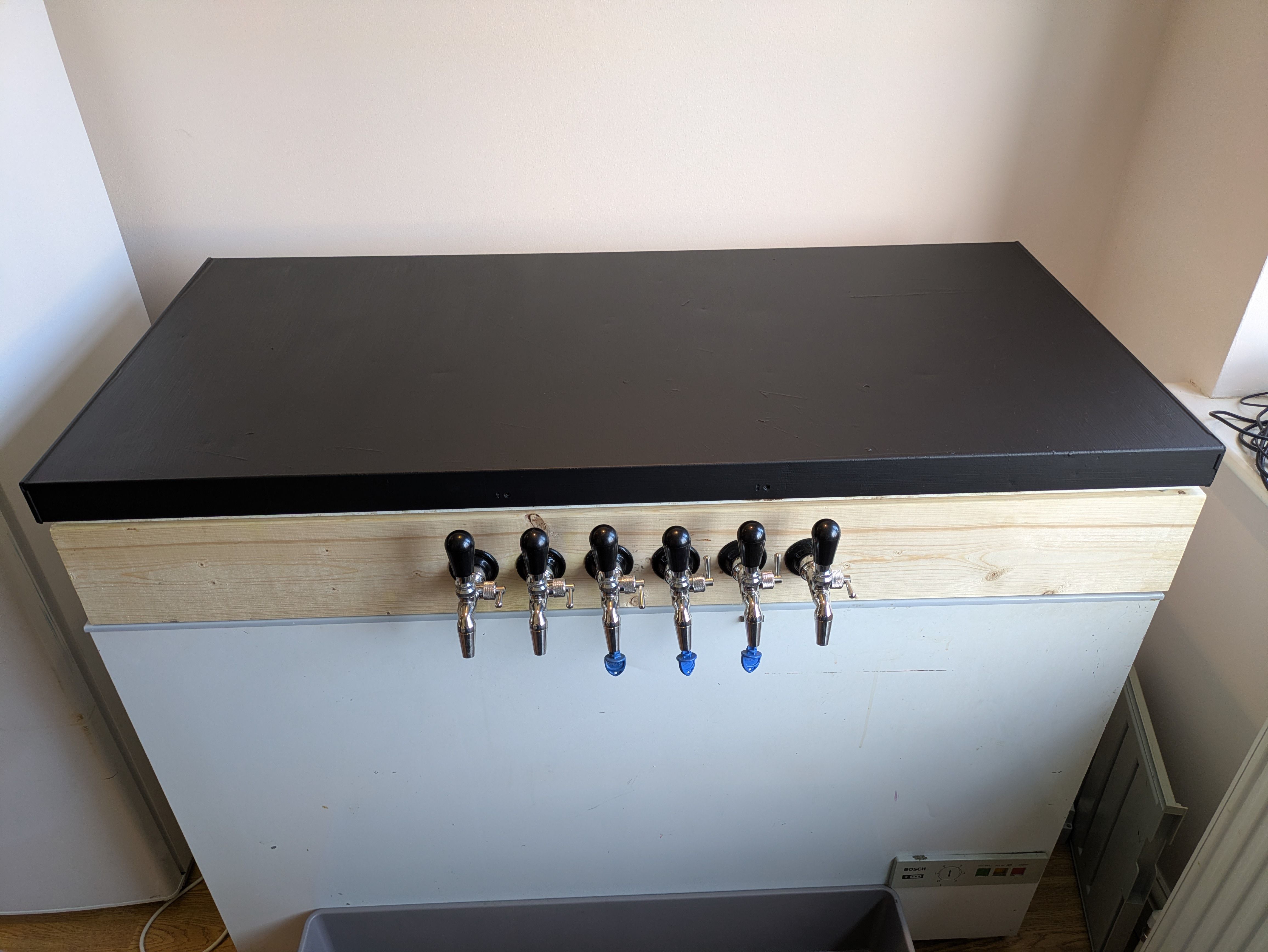 The full keezer, showing all the taps, collar, and lid painted with blackboard paint.