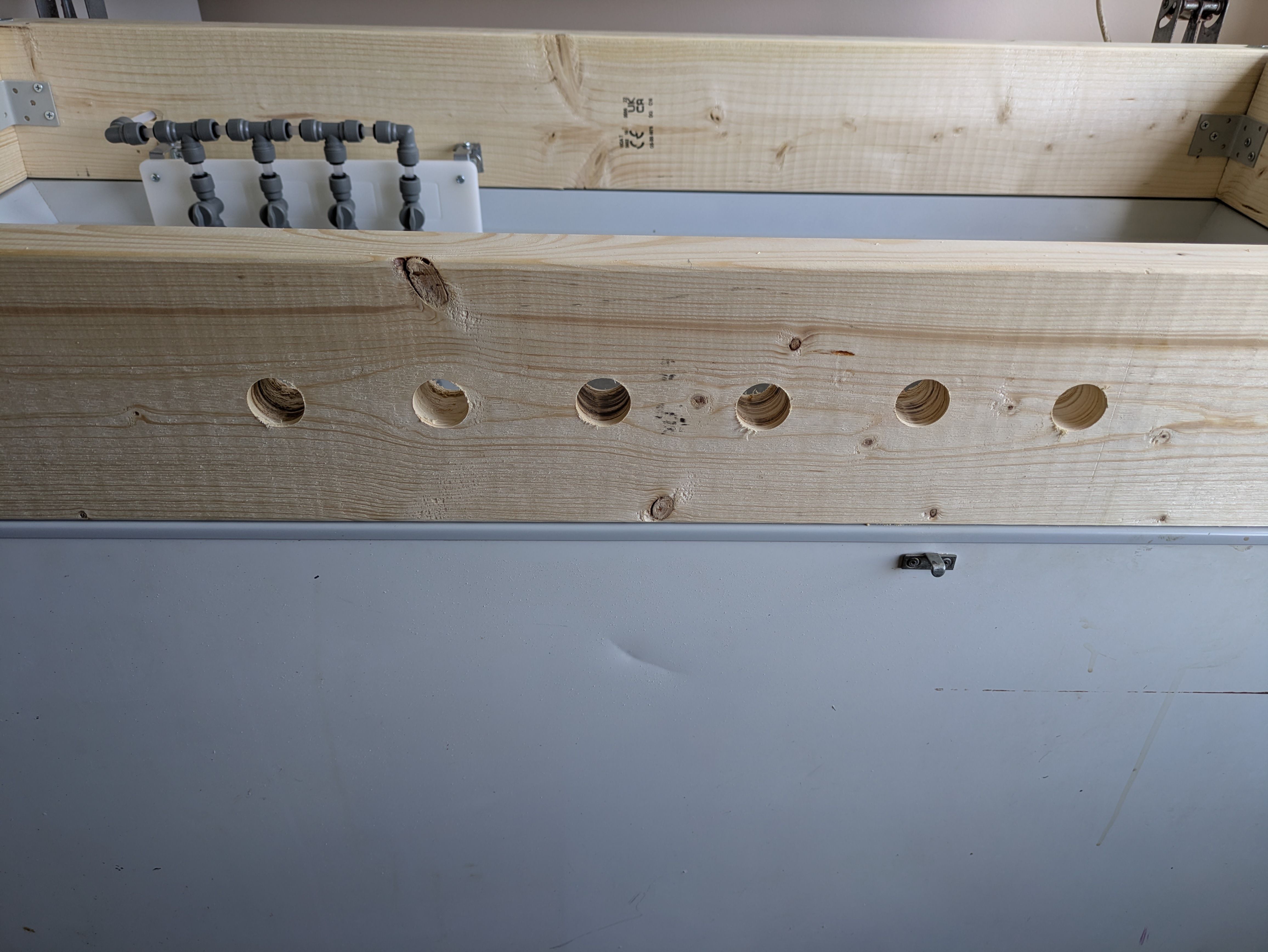 Holes drilled in the collar at 3 inch gaps for fitting tap shanks.